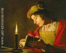 young man reading by candlelight
